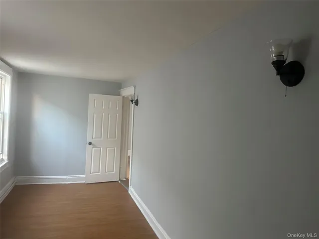 a kitchen with granite countertop white cabinets and a stove