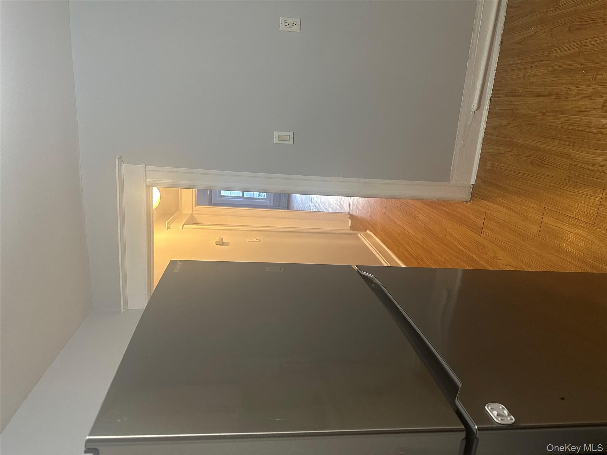 4 Ritters Lane Yonkers, NY 10703 - Photo 34 of 41 an empty room with wooden floor and door