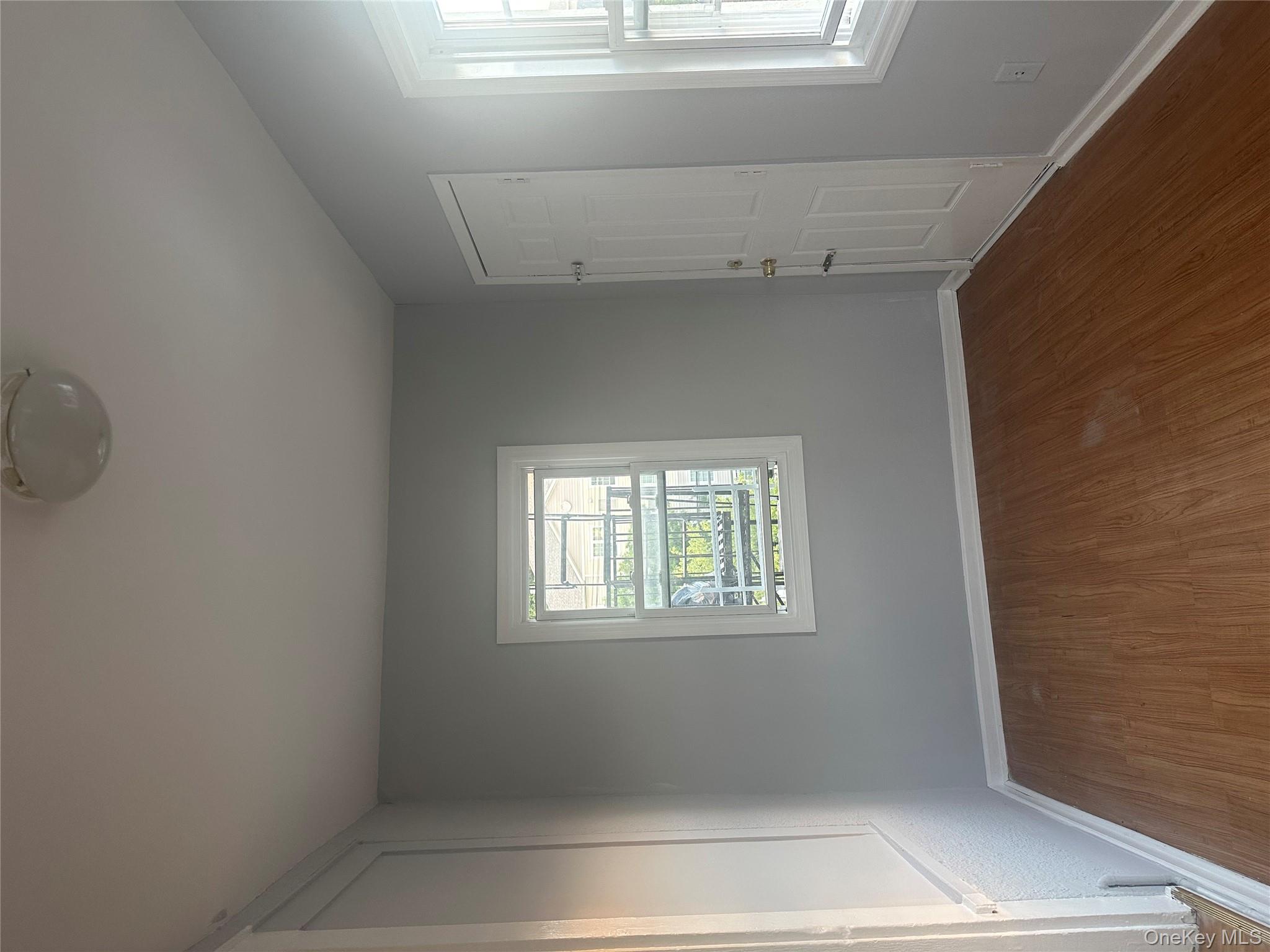 4 Ritters Lane Yonkers, NY 10703 - Photo 35 of 41 an empty room with wooden floor and windows