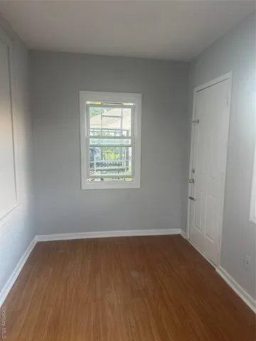 a kitchen with granite countertop white cabinets and black appliances
