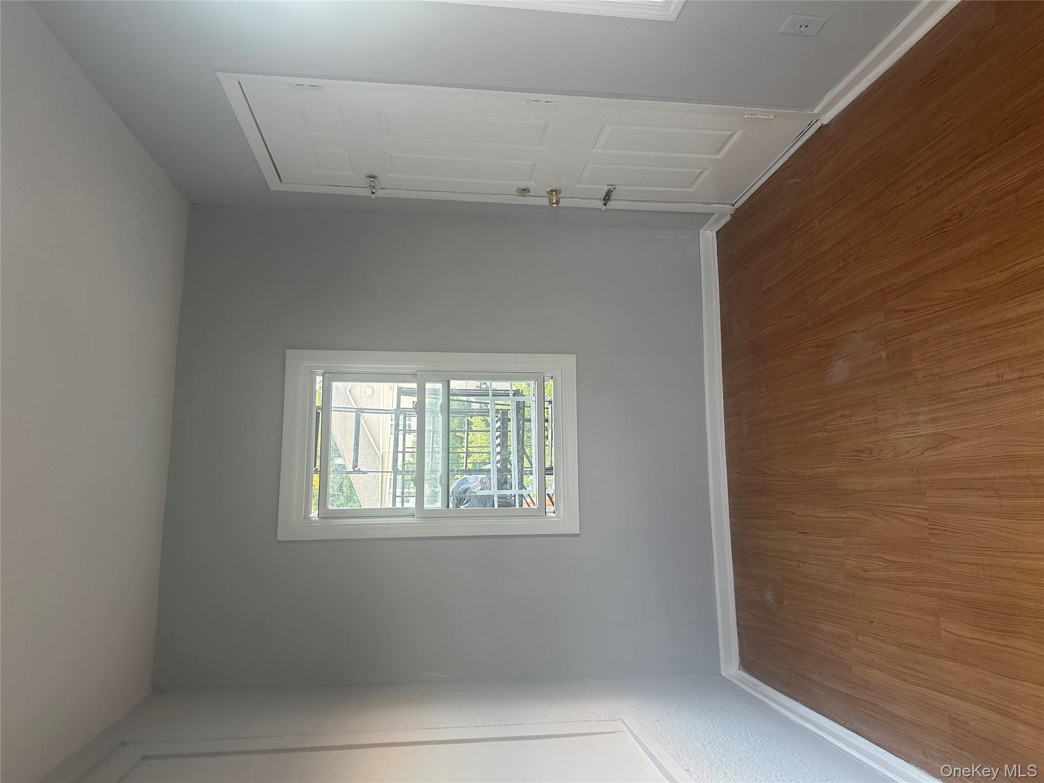 4 Ritters Lane Yonkers, NY 10703 - Photo 36 of 41 an empty room with wooden floor and windows