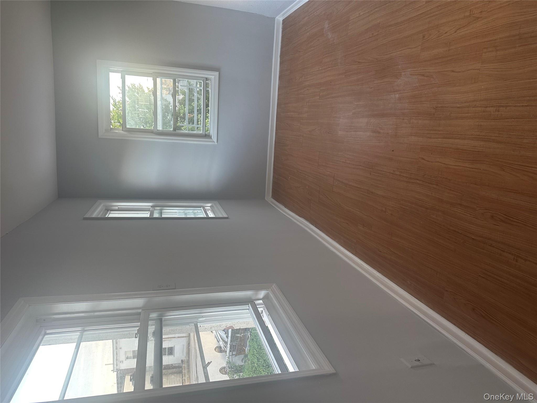 4 Ritters Lane Yonkers, NY 10703 - Photo 37 of 41 an empty room with wooden floor and windows