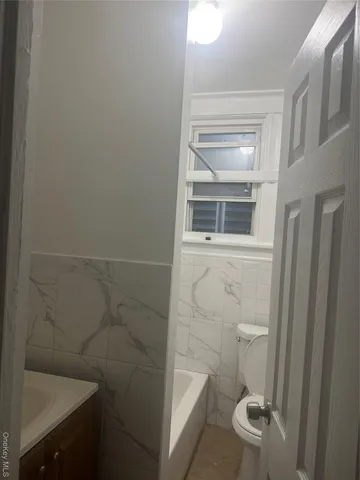 a kitchen with stainless steel appliances granite countertop a refrigerator sink and white cabinets