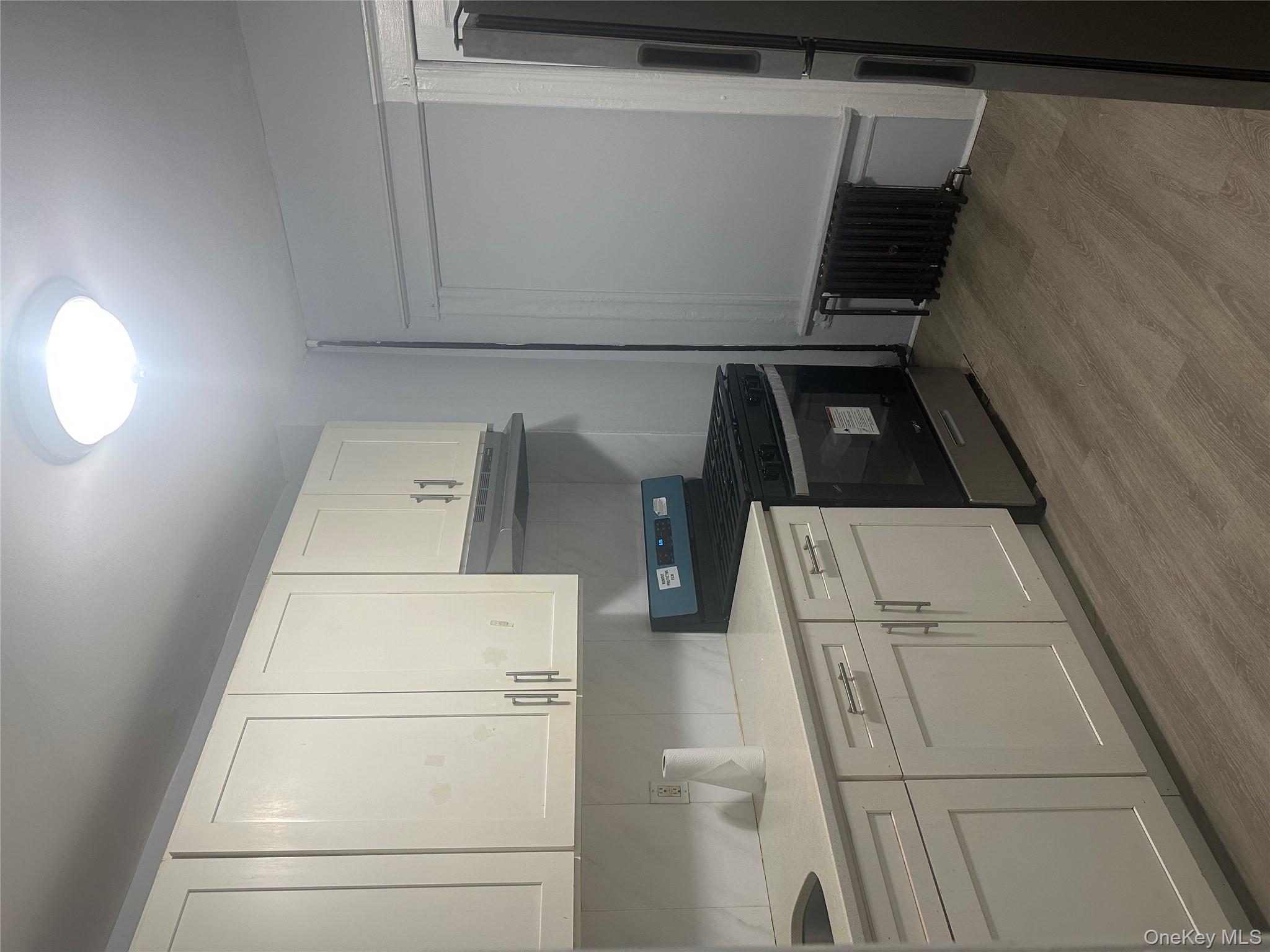 4 Ritters Lane Yonkers, NY 10703 - Photo 8 of 41 a kitchen with stainless steel appliances granite countertop a refrigerator sink and white cabinets