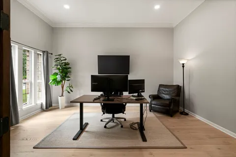 a view of a workspace with furniture and a window