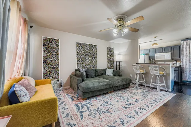a living room with furniture and a chandelier