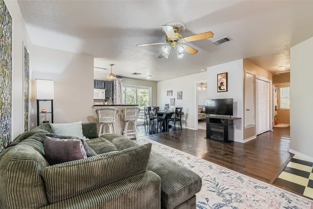 a bedroom with a bed wooden floor and a flat screen tv