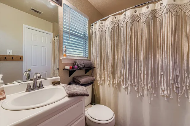 a bathroom with a sink and a mirror with toilet