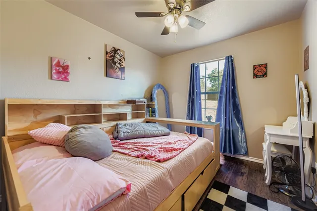 a living room with a baby crib furniture and a window