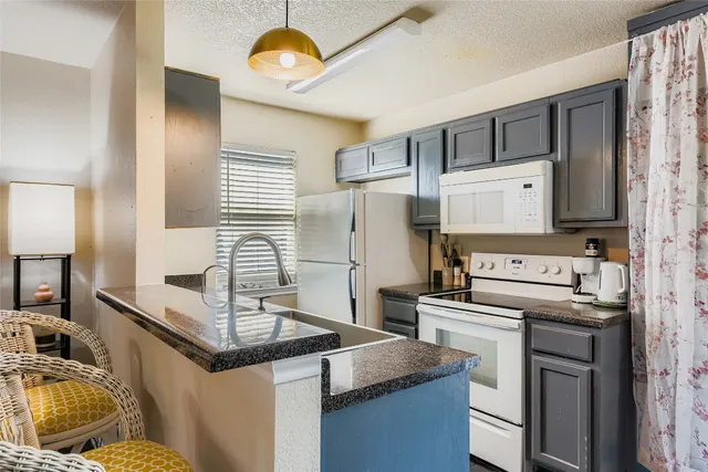 a kitchen with a sink and a refrigerator