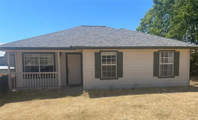 a front view of a house with a yard