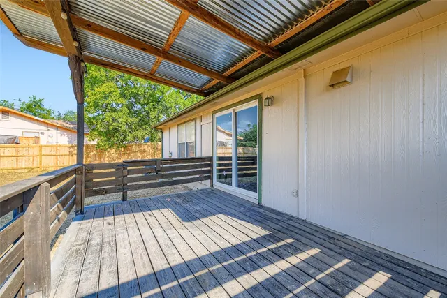 a view of a hallway with a window and a bathroom
