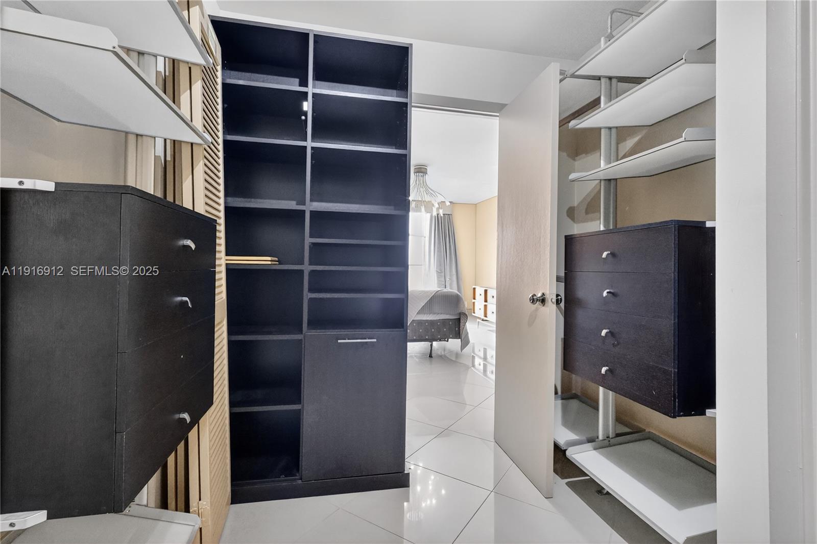 4000 Towerside Terrace, Unit 1612 Miami, FL 33138 - Photo 16 of 49 a view of walk in closet and bathroom