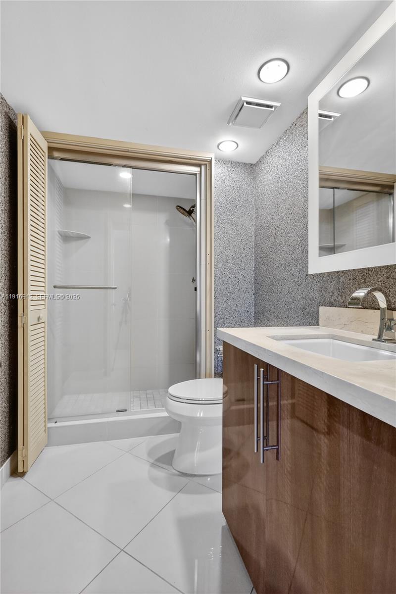 4000 Towerside Terrace, Unit 1612 Miami, FL 33138 - Photo 17 of 49 a bathroom with a sink a toilet and shower