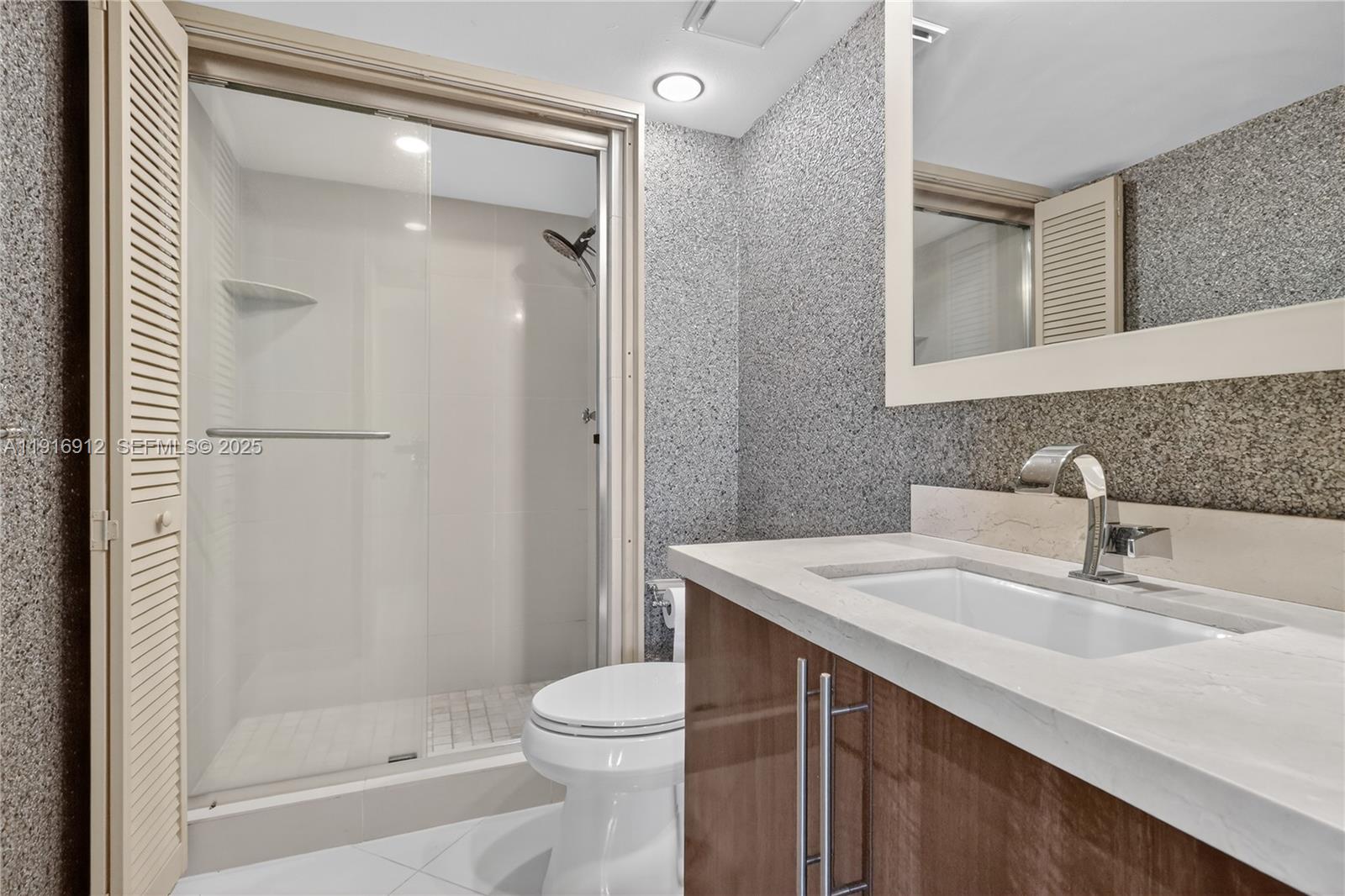 4000 Towerside Terrace, Unit 1612 Miami, FL 33138 - Photo 18 of 49 a bathroom with a sink a toilet and shower