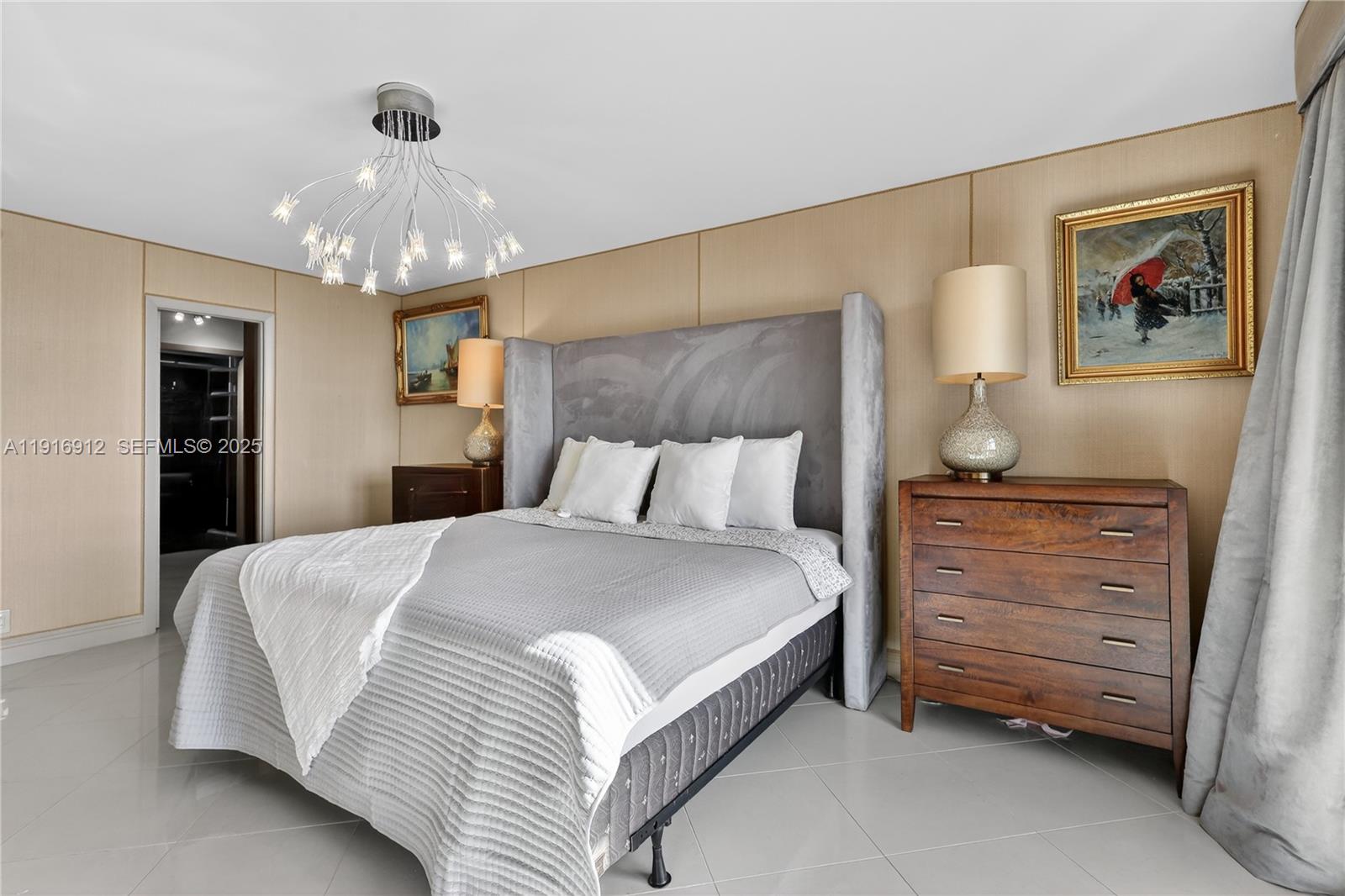 4000 Towerside Terrace, Unit 1612 Miami, FL 33138 - Photo 20 of 49 a bedroom with a bed and a chandelier