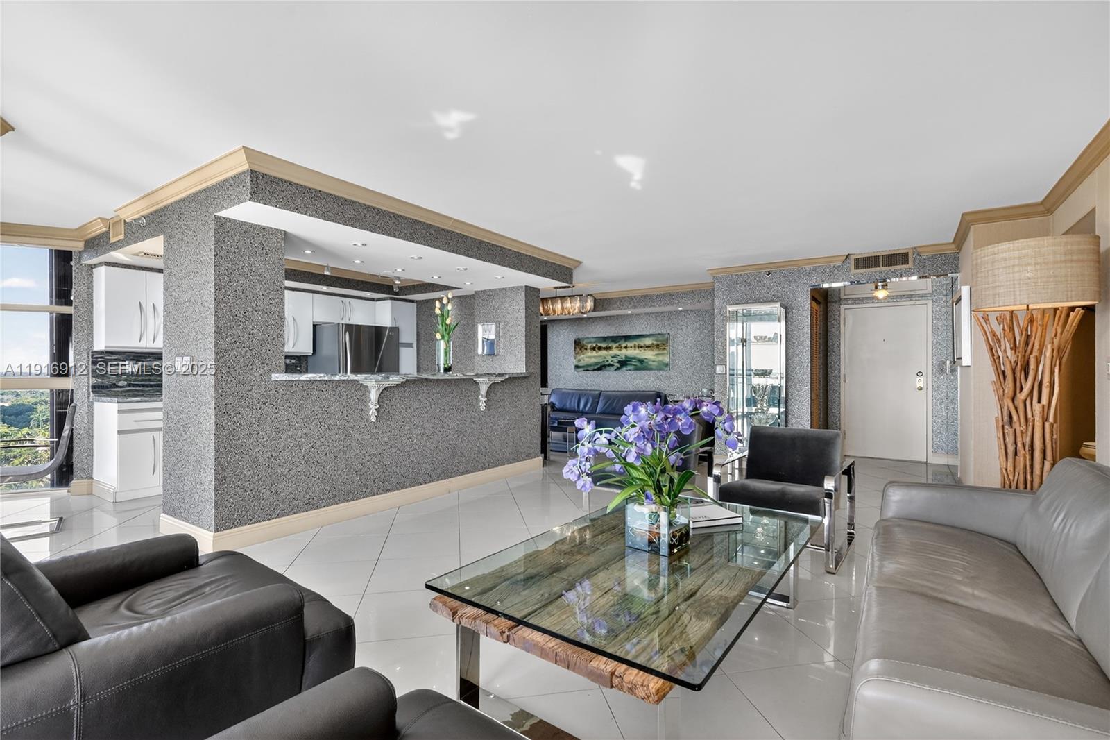 4000 Towerside Terrace, Unit 1612 Miami, FL 33138 - Photo 2 of 49 a living room with furniture and a table