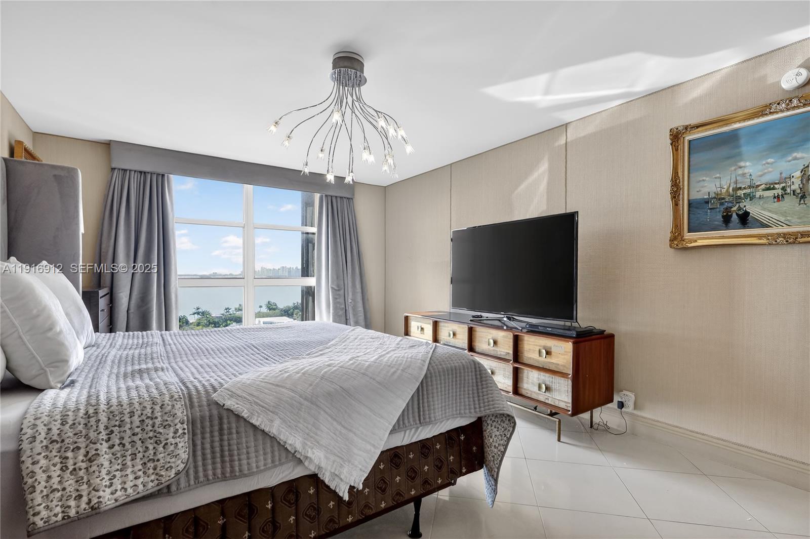 4000 Towerside Terrace, Unit 1612 Miami, FL 33138 - Photo 22 of 49 a bedroom with a bed and a flat screen tv