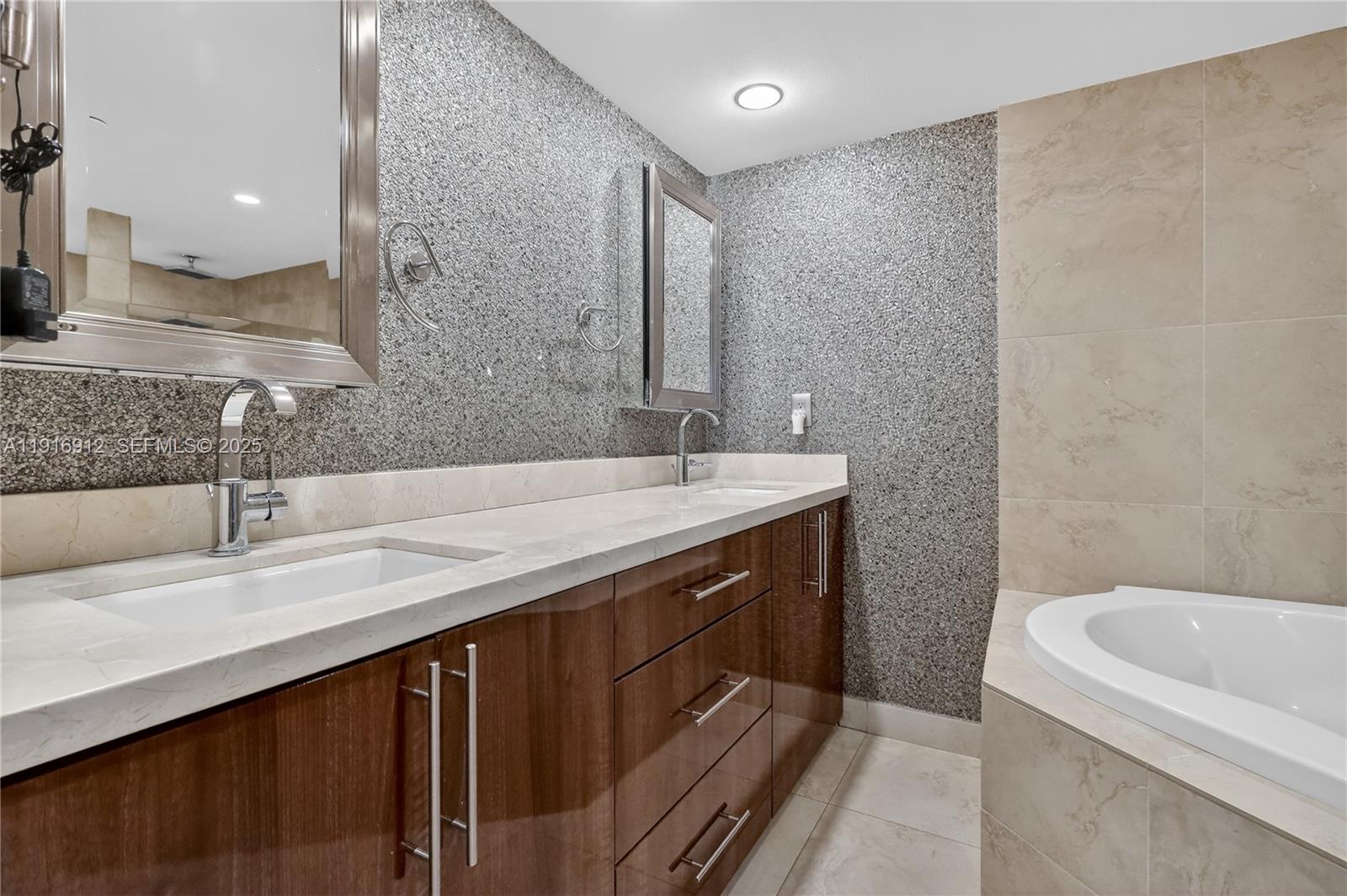 4000 Towerside Terrace, Unit 1612 Miami, FL 33138 - Photo 27 of 49 a bathroom with a double vanity sink and mirror