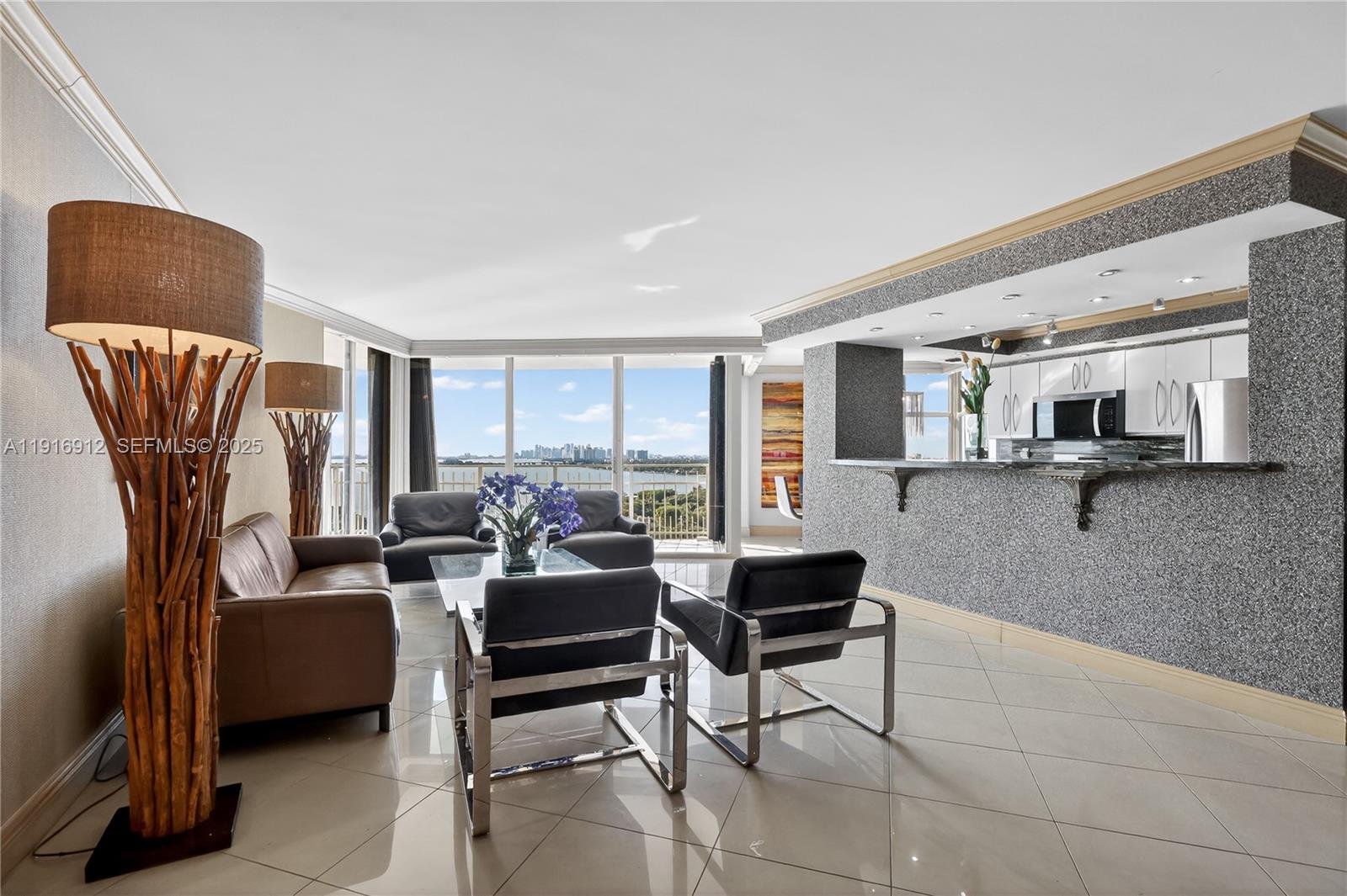 4000 Towerside Terrace, Unit 1612 Miami, FL 33138 - Photo 3 of 49 a living room with furniture and a large window