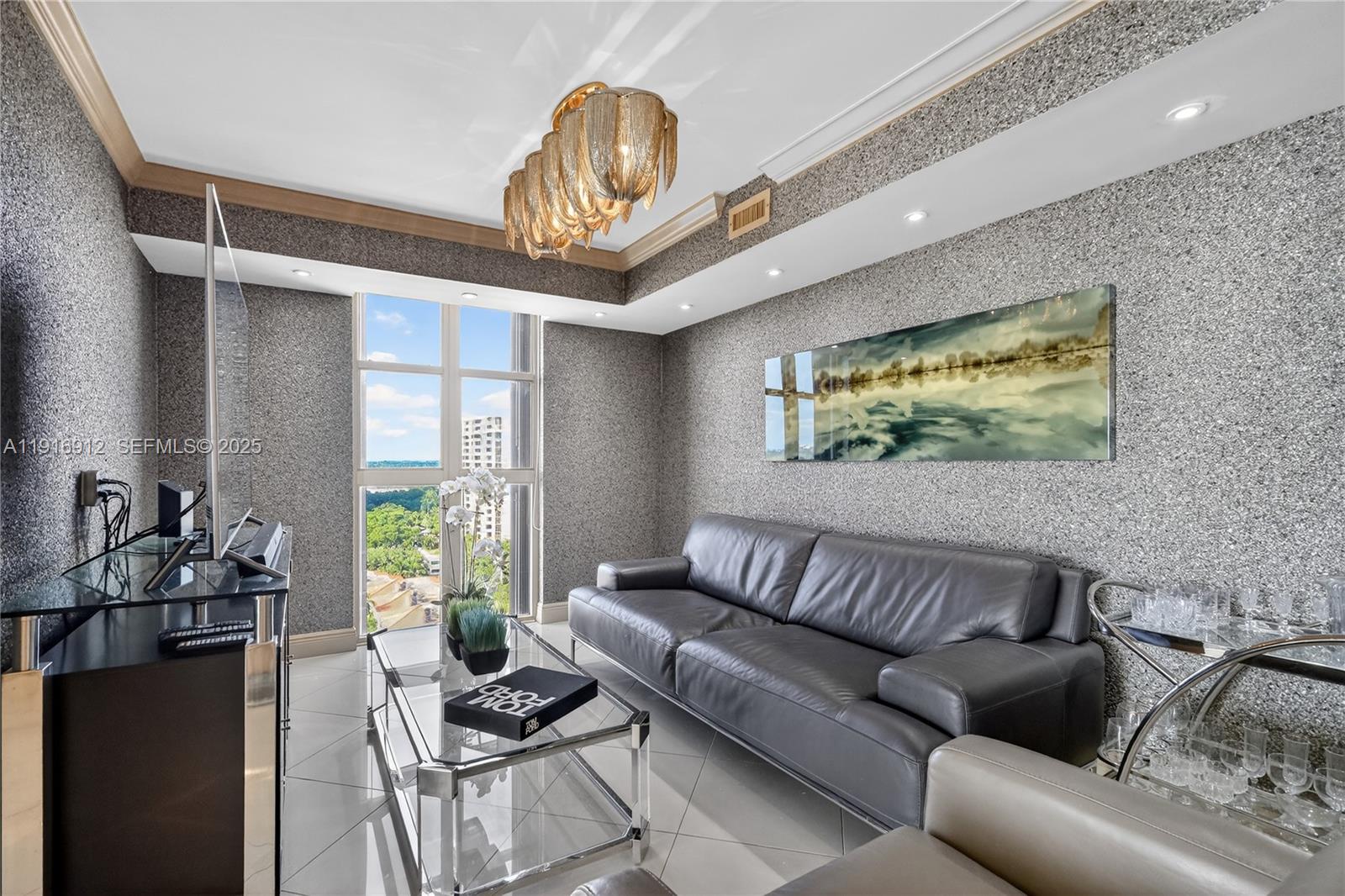 4000 Towerside Terrace, Unit 1612 Miami, FL 33138 - Photo 7 of 49 a living room with furniture and a large window