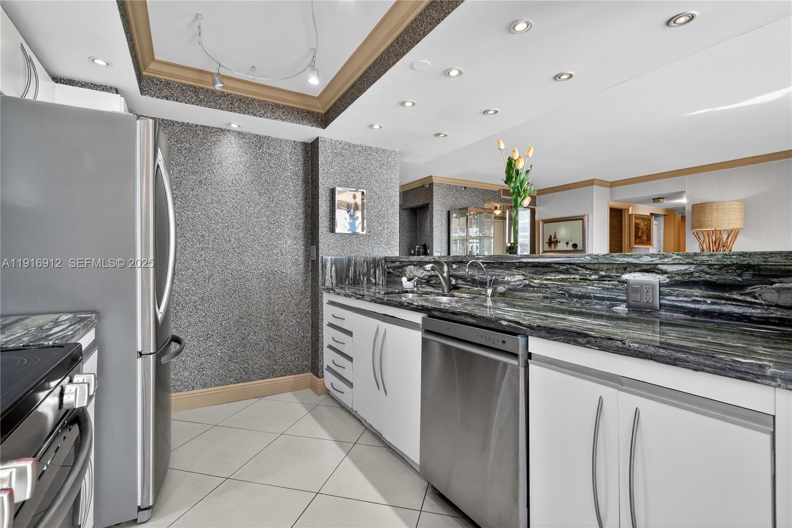 4000 Towerside Terrace, Unit 1612 Miami, FL 33138 - Photo 9 of 49 a spacious bathroom with a granite countertop sink mirror and a