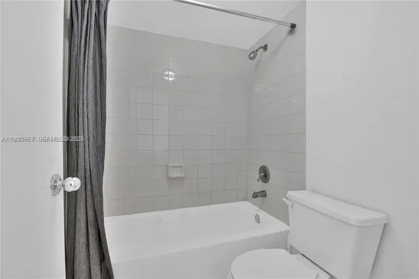 a bathroom with a toilet and a bathtub
