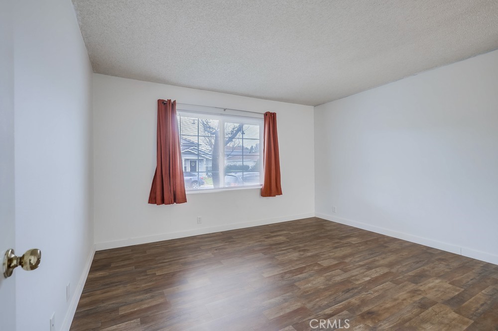 54 Eagle Run Irvine, CA 92614 - Photo 12 of 25 a view of an empty room with wooden floor and a window