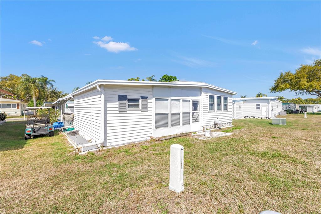 1100 South Belcher Road, Unit 502 Largo, FL 33771 - Photo 30 of 51 a front view of a house with a yard and garage
