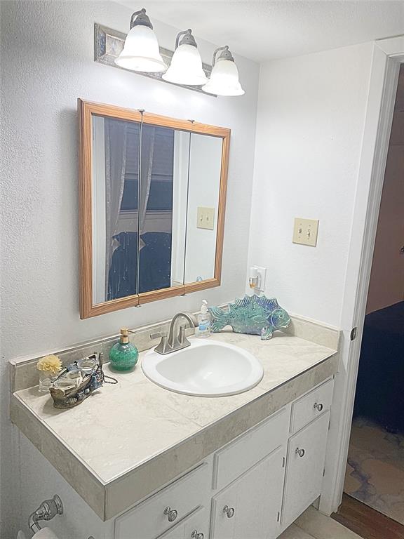 1655 Cedar Crest Loop, Unit A1 Graford, TX 76449 - Photo 11 of 15 a bathroom with a sink vanity and a mirror