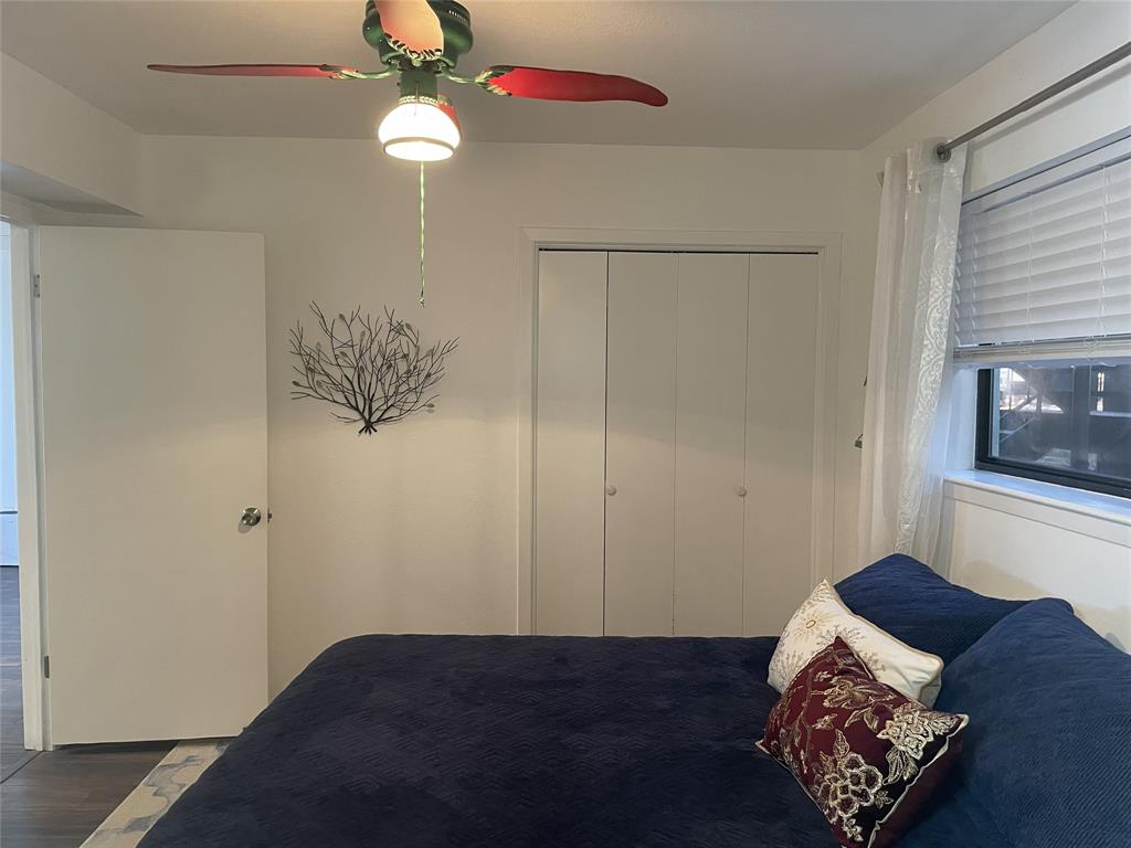 1655 Cedar Crest Loop, Unit A1 Graford, TX 76449 - Photo 12 of 15 a bed room with a bed and a chandelier fan
