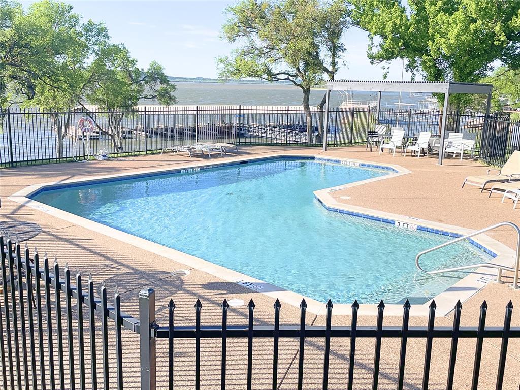 1655 Cedar Crest Loop, Unit A1 Graford, TX 76449 - Photo 14 of 15 a view of a swimming pool with a patio