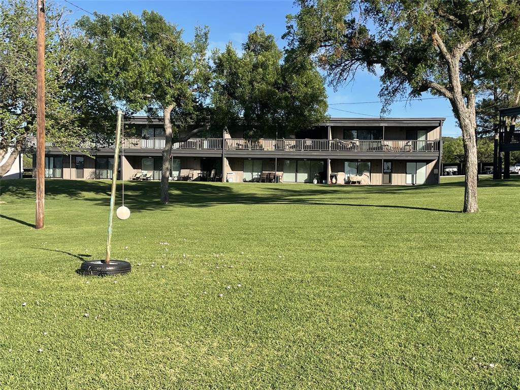 1655 Cedar Crest Loop, Unit A1 Graford, TX 76449 - Photo 3 of 15 a view of a house with a yard