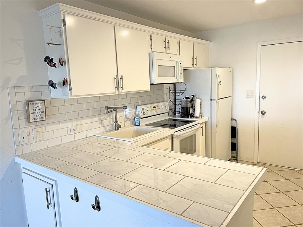 1655 Cedar Crest Loop, Unit A1 Graford, TX 76449 - Photo 6 of 15 a kitchen with a stove a refrigerator and a sink