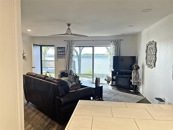 a living room with furniture a large window and a flat screen tv