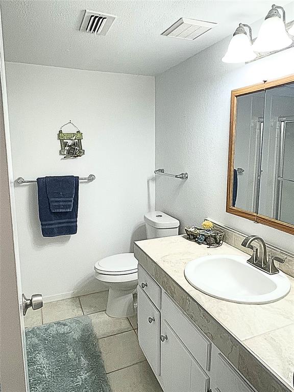 1655 Cedar Crest Loop, Unit A1 Graford, TX 76449 - Photo 10 of 15 a bathroom with a sink a toilet and a mirror