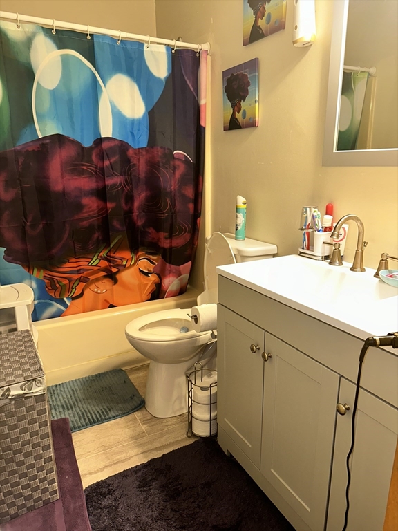 25-27 Merida Street Springfield, MA 01104 - Photo 7 of 20 a bathroom with a sink and mirror with toilet