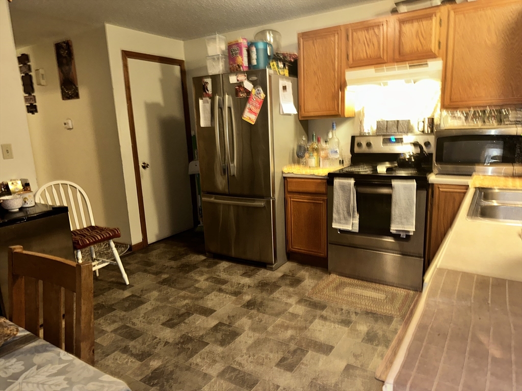 25-27 Merida Street Springfield, MA 01104 - Photo 8 of 20 a kitchen with refrigerator and window