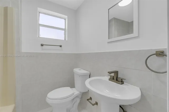 a bathroom with a sink toilet and bathtub