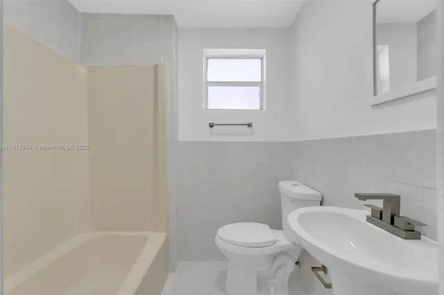 a bathroom with a shower and sink