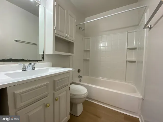 a bathroom with a sink mirror toilet and bathtub