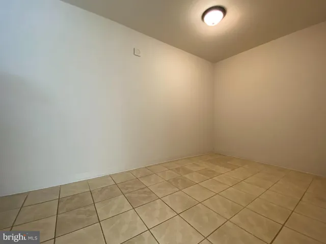 a view of a livingroom with an empty space and a window