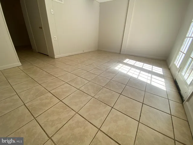 a view of backyard with green space and wooden fence