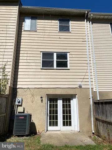 a view of a house with wooden fence
