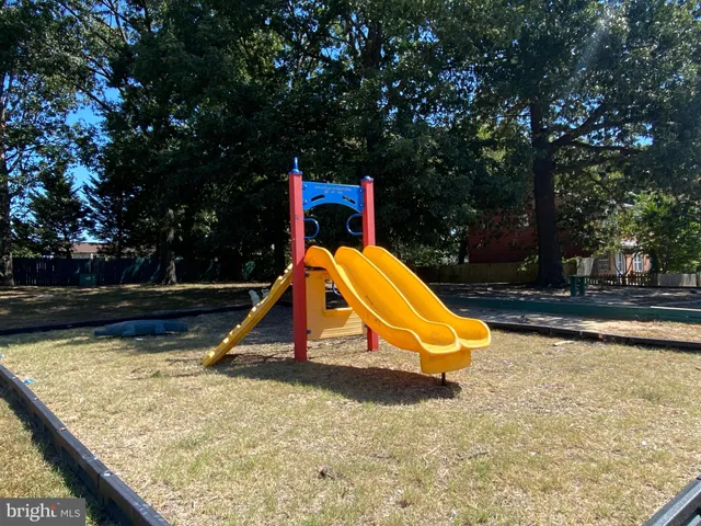 a view of a slide with a wooden bench