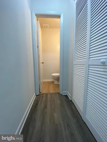 a view of a room with wooden floor