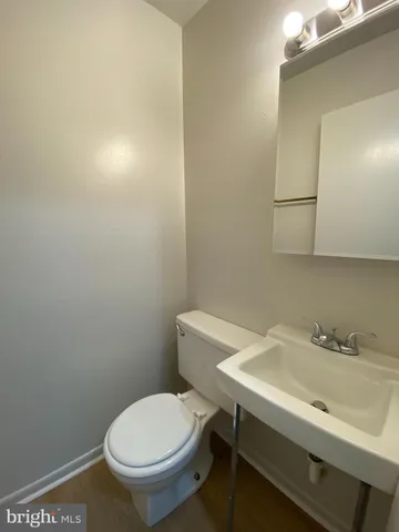 a bathroom with a sink mirror and toilet