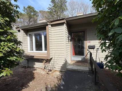 a view of house with backyard