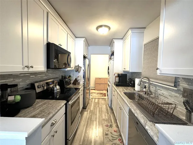 a kitchen with stainless steel appliances granite countertop a sink and cabinets
