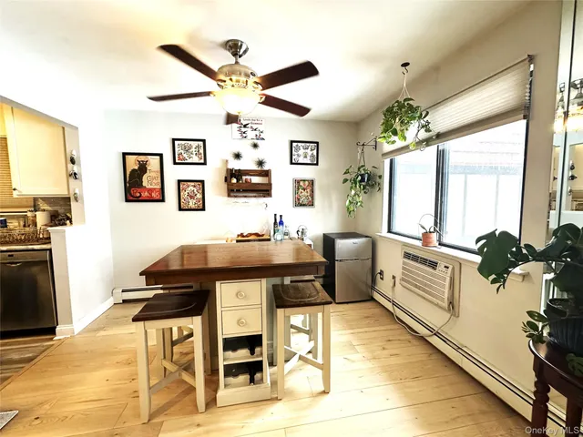 a view of a hallway with wooden floor and furniture